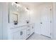 Bright bathroom featuring a double vanity with white cabinets, sleek black hardware, and a large mirror at 405 Carrera Ln, Acworth, GA 30102