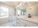 Stylish bathroom featuring a double vanity with modern fixtures, a large window, and a separate glass-enclosed shower at 405 Carrera Ln, Acworth, GA 30102