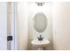 Bathroom featuring modern fixtures, a sleek pedestal sink, and a well-lit mirror at 405 Carrera Ln, Acworth, GA 30102