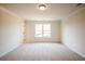 Bedroom showcasing a large window, neutral carpet, and bright natural light at 405 Carrera Ln, Acworth, GA 30102