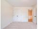 Neutral bedroom with carpet flooring, closet space, and a doorway to another room at 405 Carrera Ln, Acworth, GA 30102