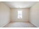 A carpeted bedroom with a window providing natural light at 405 Carrera Ln, Acworth, GA 30102