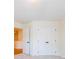 An empty bedroom with carpet floors featuring a closet with white double doors at 405 Carrera Ln, Acworth, GA 30102