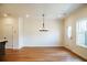 Bright dining room with a modern chandelier, neutral walls, and hardwood floors at 405 Carrera Ln, Acworth, GA 30102