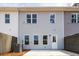 View of the rear of a home, showing siding, windows, and a small patio at 405 Carrera Ln, Acworth, GA 30102