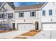 Townhome exteriors showcasing garages, varied siding colors, and manicured landscaping at 405 Carrera Ln, Acworth, GA 30102