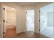 Hallway with multiple doorways leading to a bathroom, bedrooms, and featuring stylish wood flooring at 405 Carrera Ln, Acworth, GA 30102