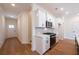 Bright kitchen featuring white cabinets, stainless steel appliances, and hardwood floors at 405 Carrera Ln, Acworth, GA 30102