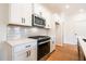 Bright kitchen with white cabinets, stainless steel appliances and subway tile backsplash offers a modern design at 405 Carrera Ln, Acworth, GA 30102