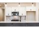 Close-up of a modern kitchen island with quartz countertops, stainless steel appliances, and stylish lighting at 405 Carrera Ln, Acworth, GA 30102