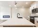 Spacious kitchen with a large island, modern lighting, stainless steel appliances and a cozy fireplace at 405 Carrera Ln, Acworth, GA 30102