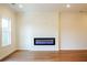 Modern living room featuring an electric fireplace and natural light from a window at 405 Carrera Ln, Acworth, GA 30102