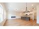 Open-concept living space featuring hardwood floors, fireplace, and kitchen island at 405 Carrera Ln, Acworth, GA 30102