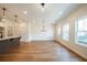 Open-concept living area with hardwood floors, modern lighting and multiple windows at 405 Carrera Ln, Acworth, GA 30102