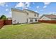 Spacious backyard featuring a well-maintained lawn and a privacy fence at 5273 High Tide Ct, Atlanta, GA 30349