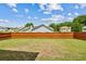Large, open backyard with a well-manicured lawn and a tall wooden privacy fence at 5273 High Tide Ct, Atlanta, GA 30349