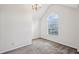 Comfortable carpeted bedroom features a vaulted ceiling and a large window at 5273 High Tide Ct, Atlanta, GA 30349