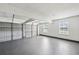 Spacious three car garage with two windows and gray painted concrete floor at 5273 High Tide Ct, Atlanta, GA 30349