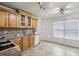 Bright kitchen features tile floor, natural wood cabinets, and matching backsplash at 5273 High Tide Ct, Atlanta, GA 30349