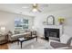 Cozy living room featuring a fireplace, ceiling fan, and neutral decor for relaxation at 5273 High Tide Ct, Atlanta, GA 30349