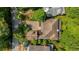 A birds eye view of a large house with a courtyard and driveway surrounded by green landscaping at 9179 Selborne Ln, Chattahoochee Hills, GA 30268
