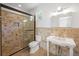 Bathroom featuring a tile shower, toilet, and sink at 9179 Selborne Ln, Chattahoochee Hills, GA 30268