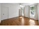 Bedroom with hardwood floors, curtains, and natural light at 9179 Selborne Ln, Chattahoochee Hills, GA 30268