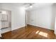 Bedroom featuring hardwood floors, ceiling fan, and a bathroom entrance at 9179 Selborne Ln, Chattahoochee Hills, GA 30268