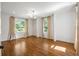 Bedroom featuring hardwood floors and two large windows at 9179 Selborne Ln, Chattahoochee Hills, GA 30268