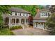 Charming home with a welcoming front porch and attached garage; beautiful landscaping at 9179 Selborne Ln, Chattahoochee Hills, GA 30268