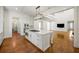 Spacious kitchen with island opens to living room in an open-concept design; great for entertaining at 9179 Selborne Ln, Chattahoochee Hills, GA 30268