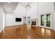 Bright living room with high ceilings, fireplace, French doors to the outside, and a modern design at 9179 Selborne Ln, Chattahoochee Hills, GA 30268