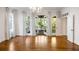 Open living room with access to a screened-in porch, featuring hardwood floors and natural light at 9179 Selborne Ln, Chattahoochee Hills, GA 30268
