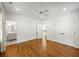 Spacious main bedroom with hardwood floors, ensuite bathroom, and closet at 9179 Selborne Ln, Chattahoochee Hills, GA 30268