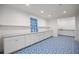 Mud room with blue patterned flooring, lots of built-in cabinet storage and access to sink area at 9179 Selborne Ln, Chattahoochee Hills, GA 30268