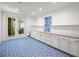 Mud room with blue patterned flooring, lots of built-in cabinet storage and outdoor access at 9179 Selborne Ln, Chattahoochee Hills, GA 30268