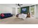 Spacious bedroom with a ceiling fan, a sofa, and two large windows for natural light at 1028 Riverbend Club Se Dr, Atlanta, GA 30339