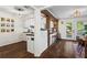 Open-concept dining area leading into a kitchen with bar seating and a view of the backyard at 1028 Riverbend Club Se Dr, Atlanta, GA 30339