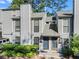 Charming townhome featuring a well-maintained front yard with lush greenery and a gray-toned exterior at 1028 Riverbend Club Se Dr, Atlanta, GA 30339