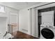 Bright hallway with a laundry closet and a railing leading to another room at 1028 Riverbend Club Se Dr, Atlanta, GA 30339