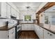 Well-lit kitchen with white cabinets, stainless steel appliances, and ample counter space at 1028 Riverbend Club Se Dr, Atlanta, GA 30339