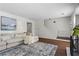 Bright living room with hardwood floors, a cozy sectional, and a staircase leading to the upper level at 1028 Riverbend Club Se Dr, Atlanta, GA 30339