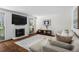 Inviting living area boasts a fireplace, large TV, and a comfortable sectional sofa at 1028 Riverbend Club Se Dr, Atlanta, GA 30339