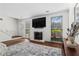 Bright living area features fireplace, large TV, and a comfortable sectional sofa at 1028 Riverbend Club Se Dr, Atlanta, GA 30339