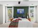 Stylish bedroom featuring green accent wall, matching side tables, windows and abstract art at 1028 Riverbend Club Se Dr, Atlanta, GA 30339
