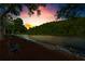 Scenic river view at sunset with seating and trees in the background at 1028 Riverbend Club Se Dr, Atlanta, GA 30339