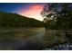 Scenic river view with lush trees and a colorful sunset sky at 1028 Riverbend Club Se Dr, Atlanta, GA 30339
