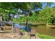 Picturesque view with chairs overlooking a tranquil river and lush greenery at 1028 Riverbend Club Se Dr, Atlanta, GA 30339
