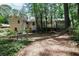 Back exterior of a brick home with a fenced-in backyard and patio at 1819 King Alfred Sw Dr, Atlanta, GA 30331
