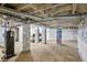 Unfinished basement with exposed beams and block foundation with a water heater at 1819 King Alfred Sw Dr, Atlanta, GA 30331